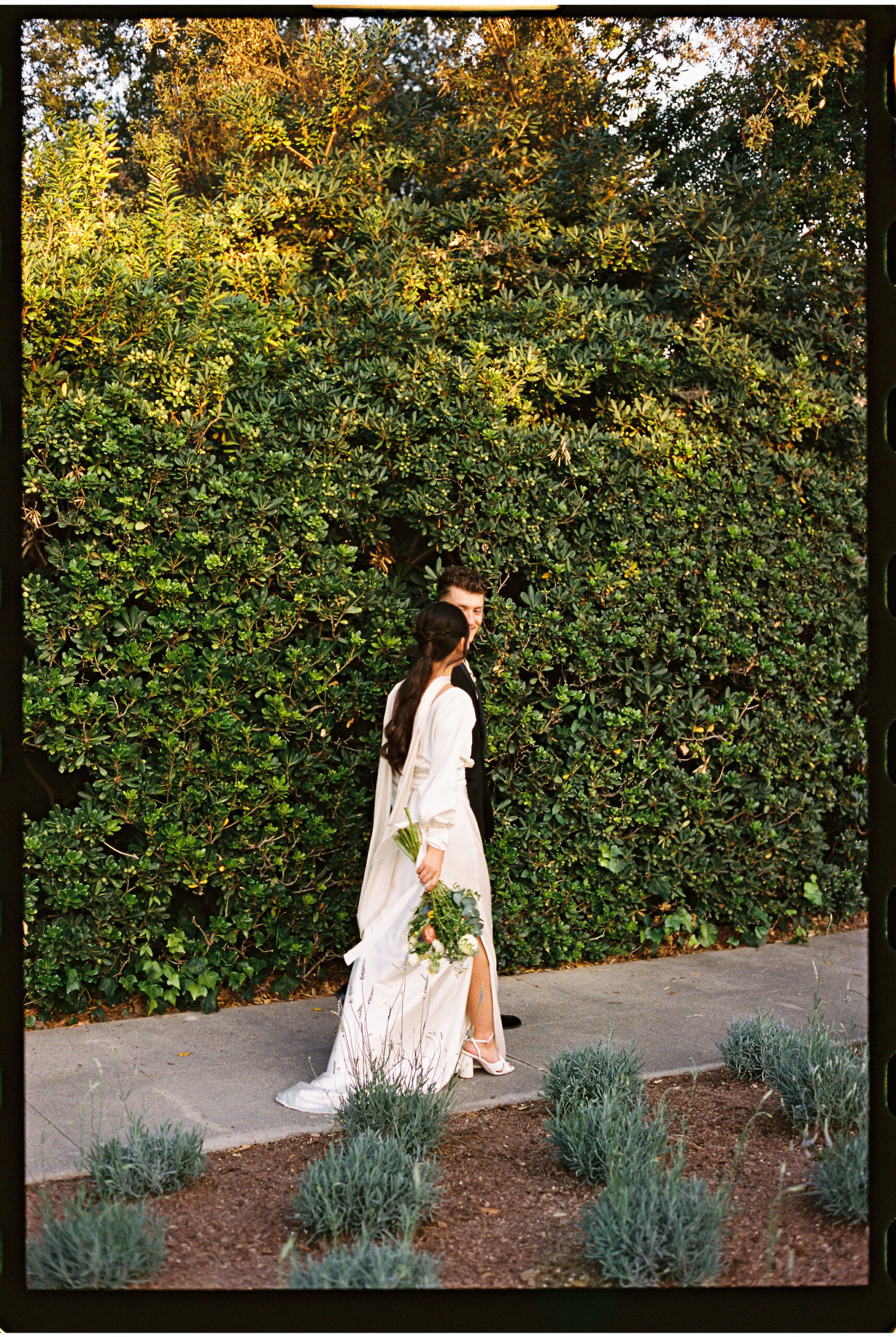 bride and groom take their documentary style wedding photos outdoors