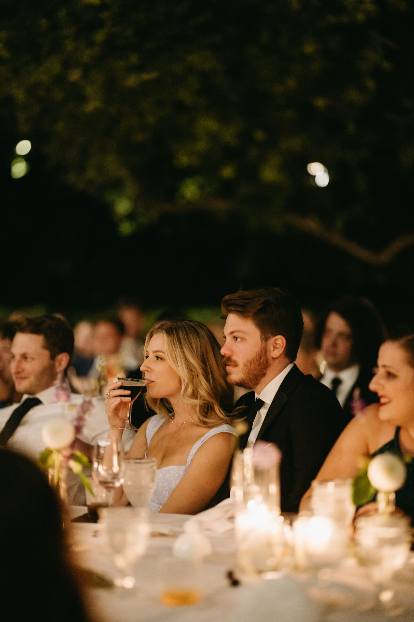 Guests enjoy a wedding reception at a private residence for a backyard wedding 