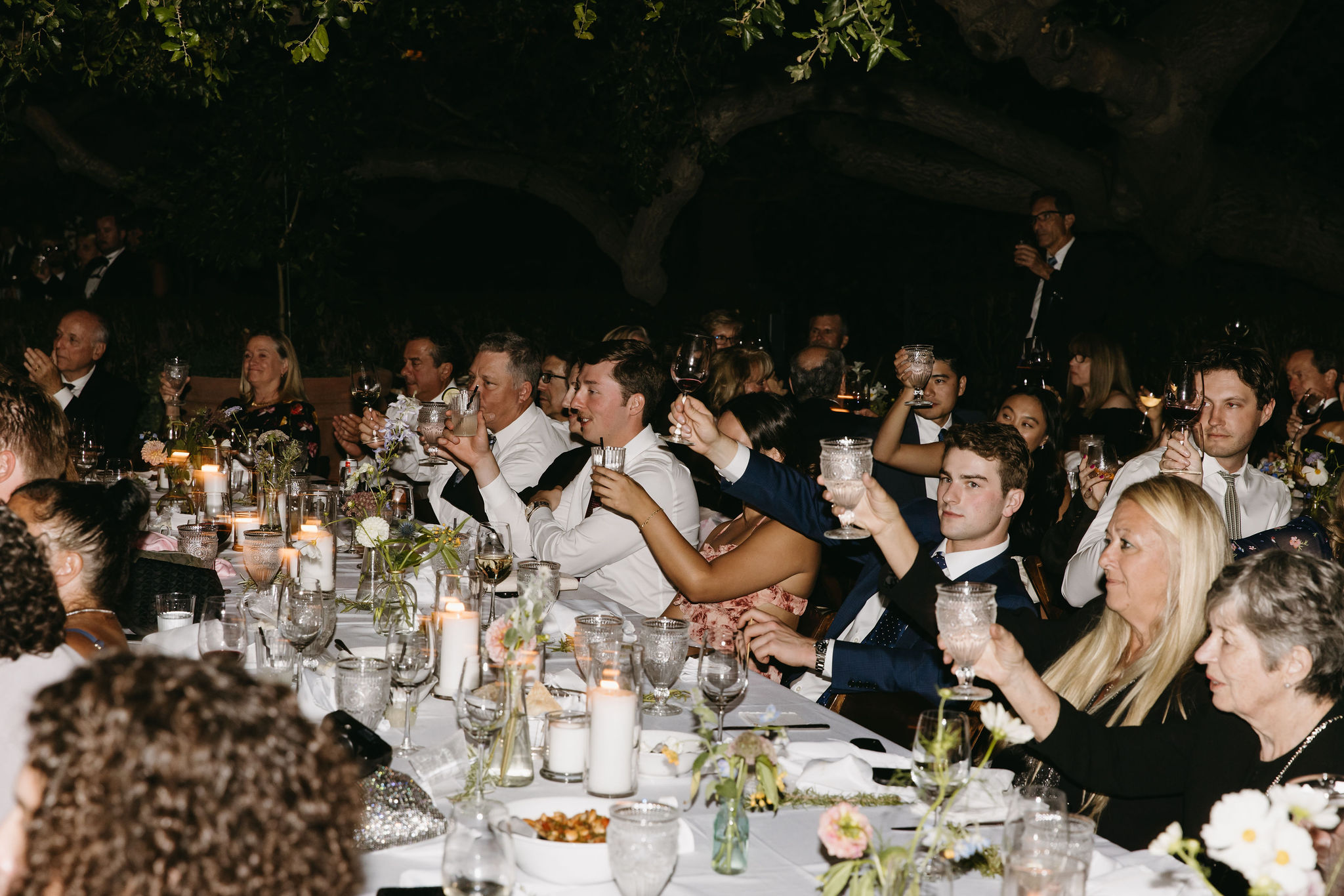 Guests enjoy a wedding reception at a private residence for a backyard wedding 