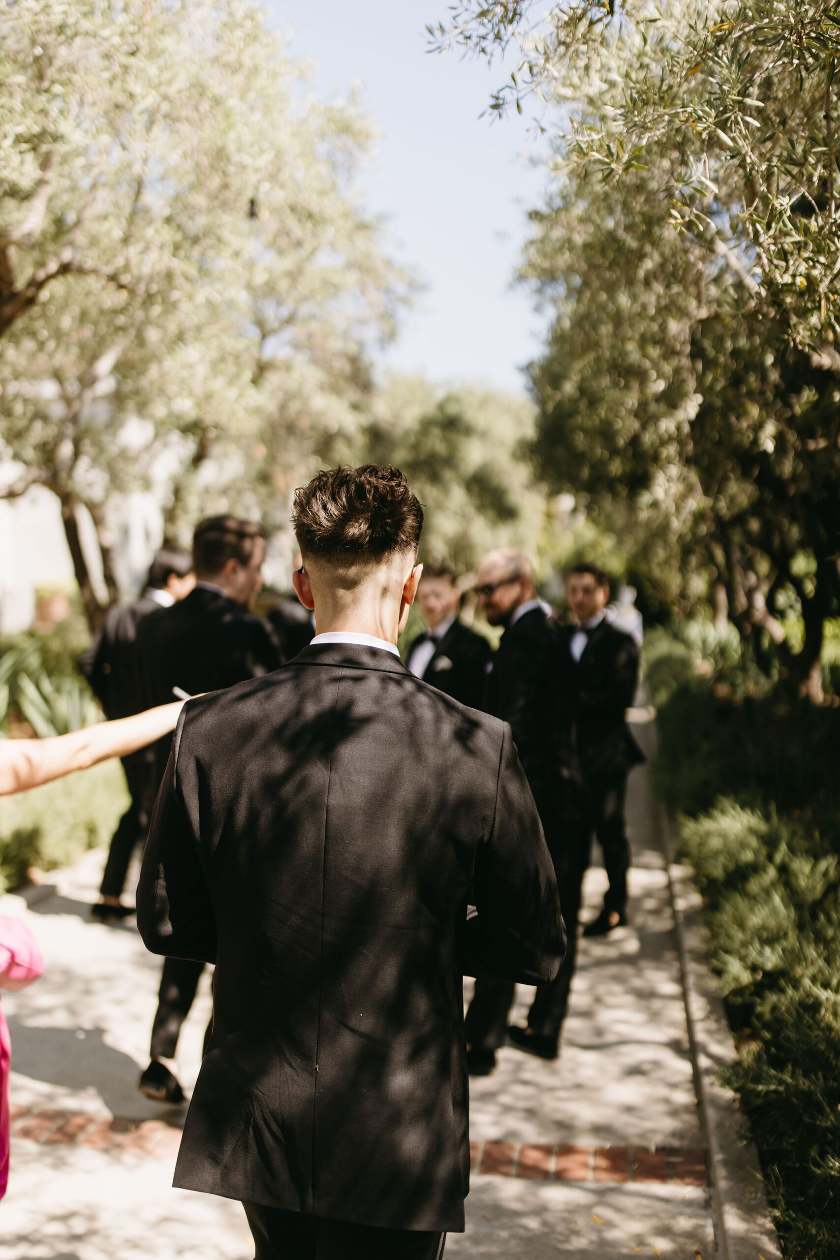 groom and groomsmen taking bridal party photos outdoors | documentary style wedding photos