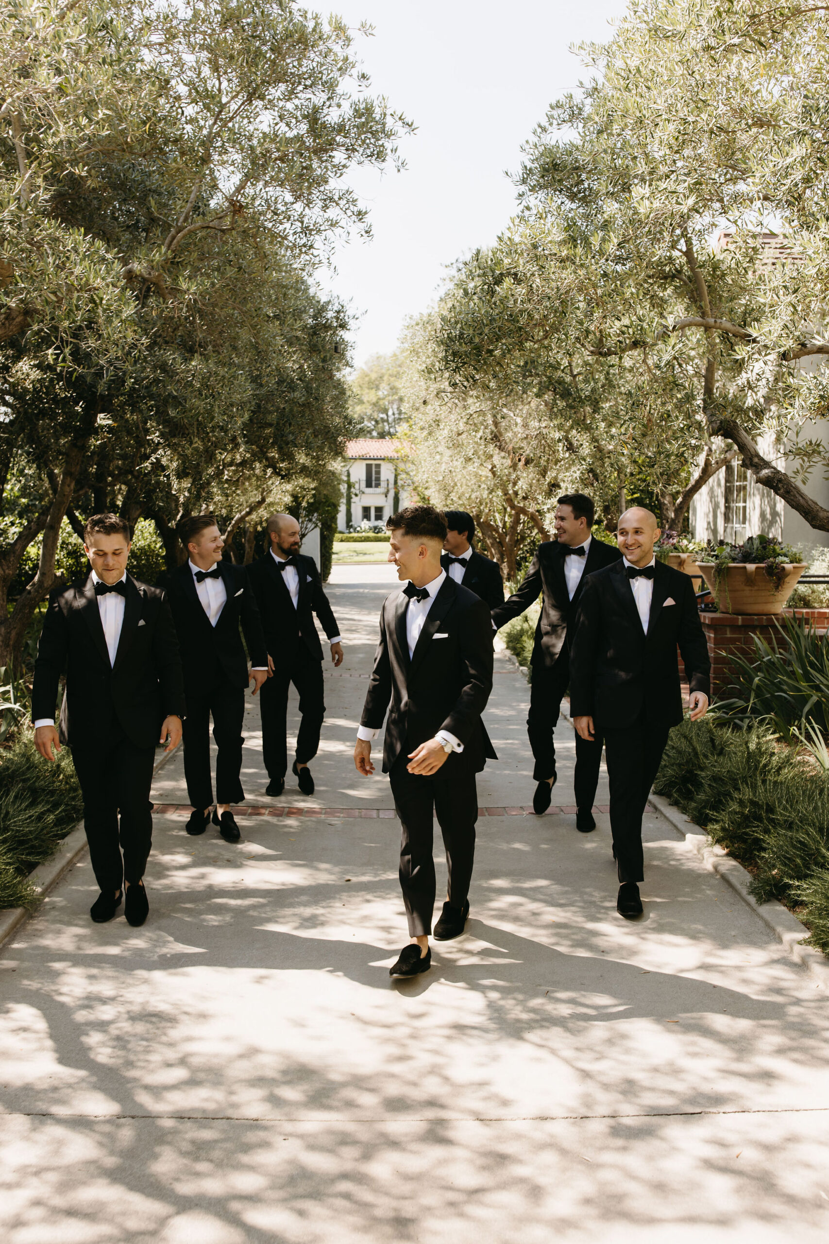 groom and groomsmen taking bridal party photos outdoors | documentary style wedding photos