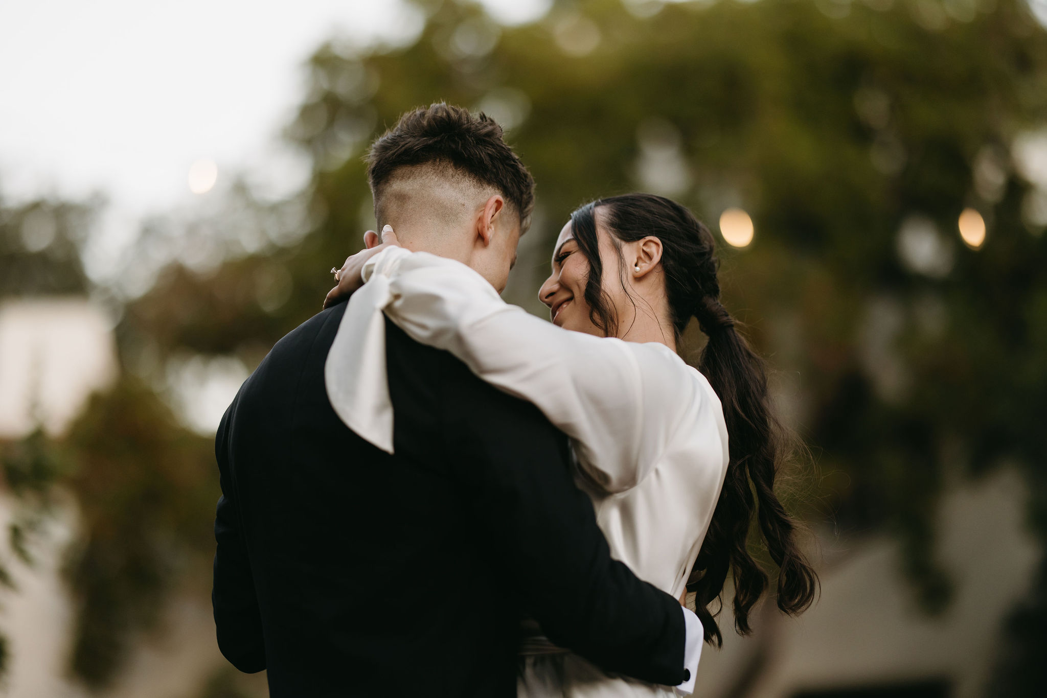 bride and groom take their documentary style wedding photos  outdoors as they do their first dance