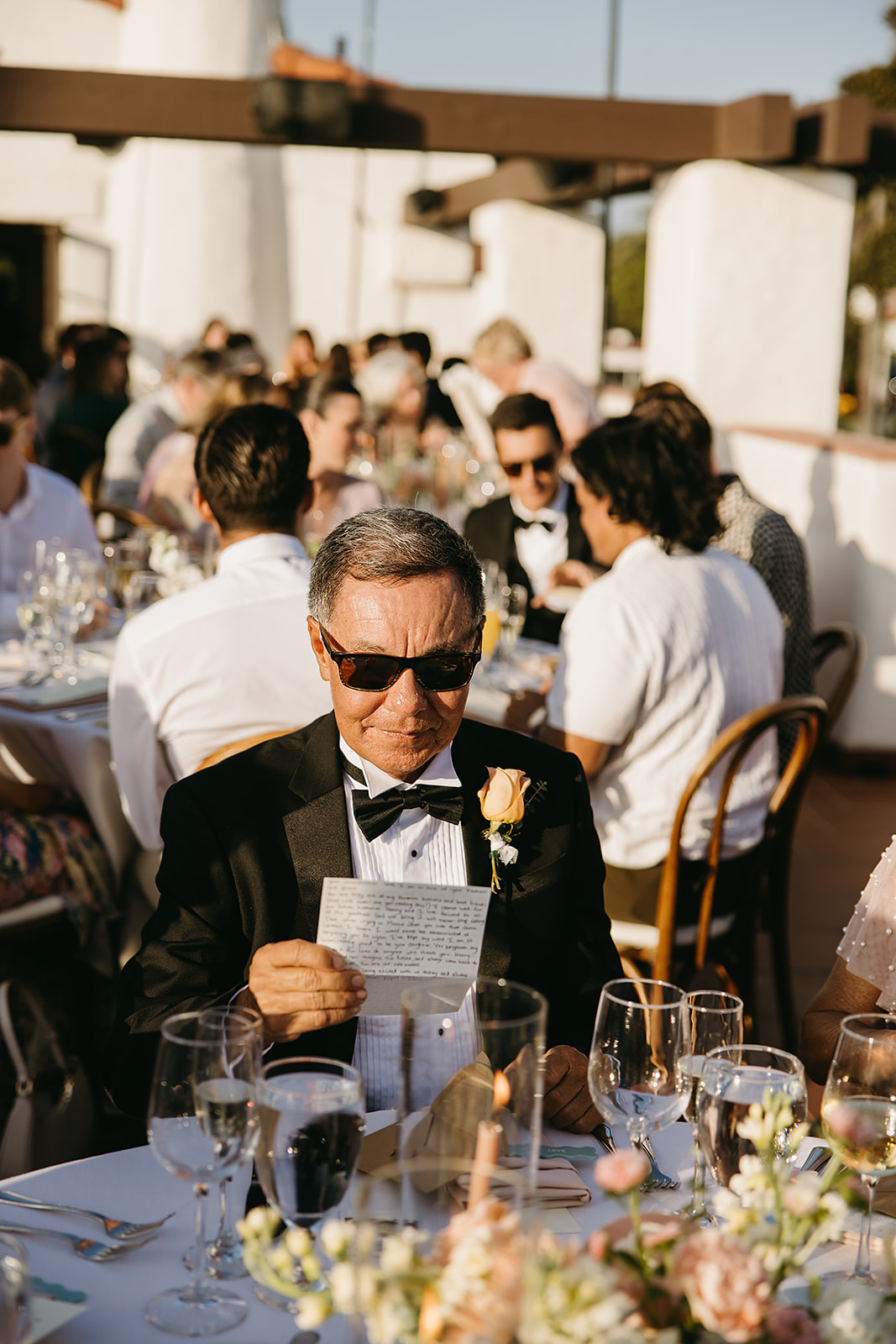 People reading hand written letters from the bride and groom at a wedding reception at Ole Hanson