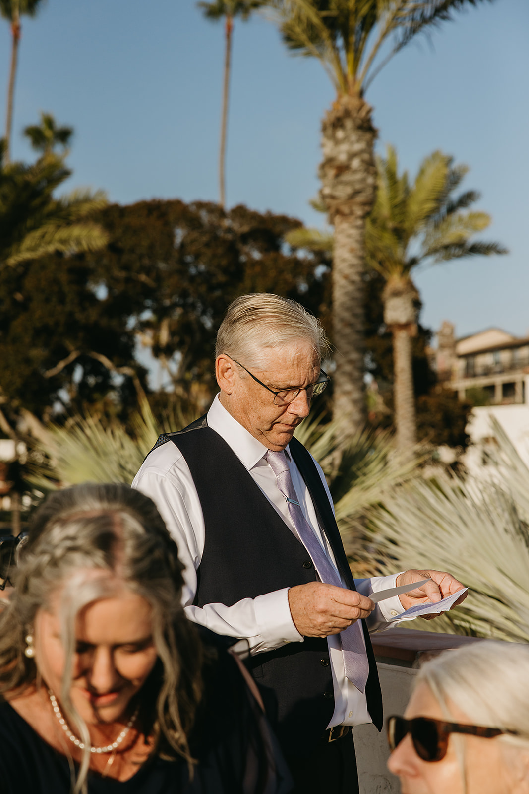 People reading hand written letters from the bride and groom at a wedding reception at Ole Hanson