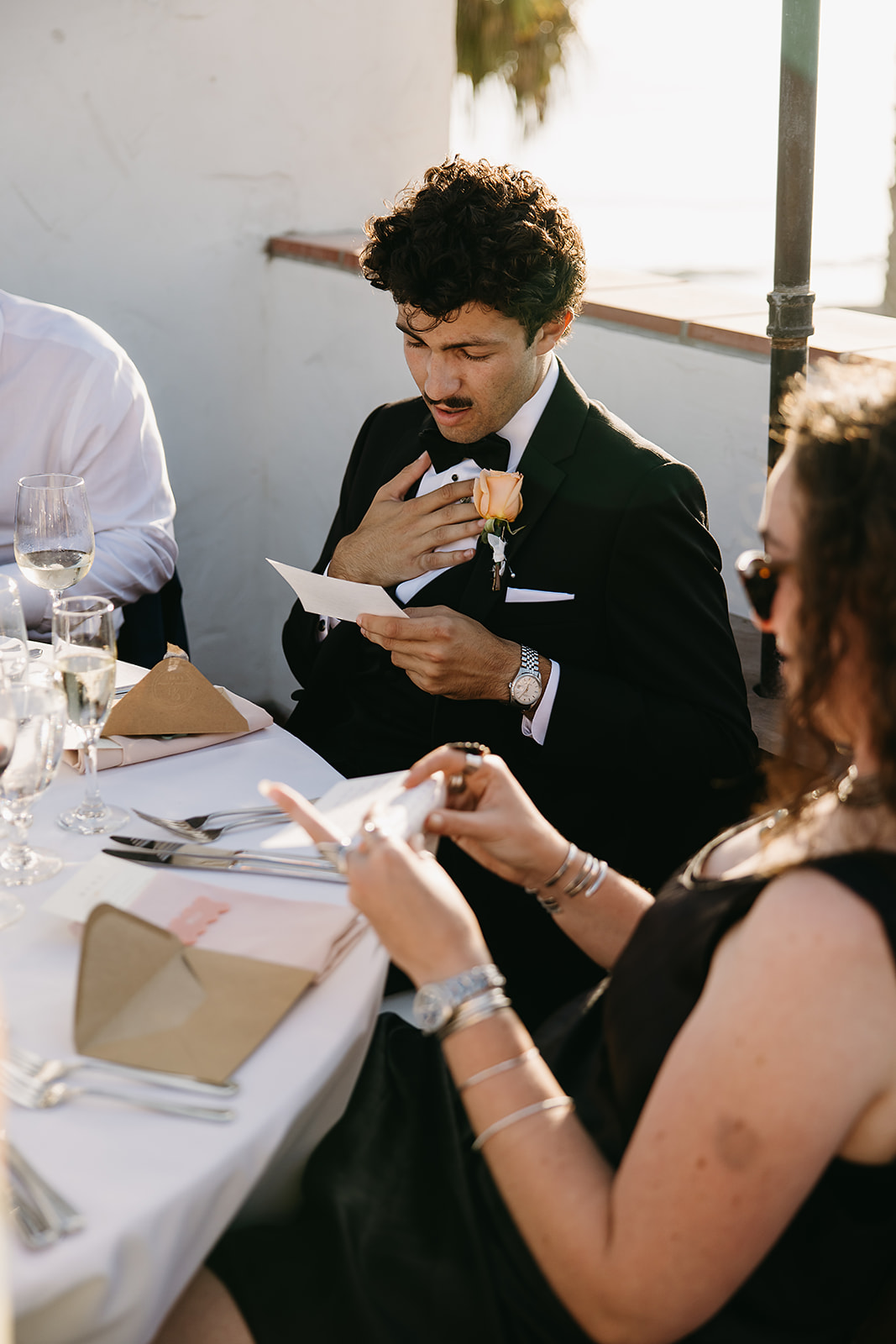 People reading hand written letters from the bride and groom at a wedding reception at Ole Hanson