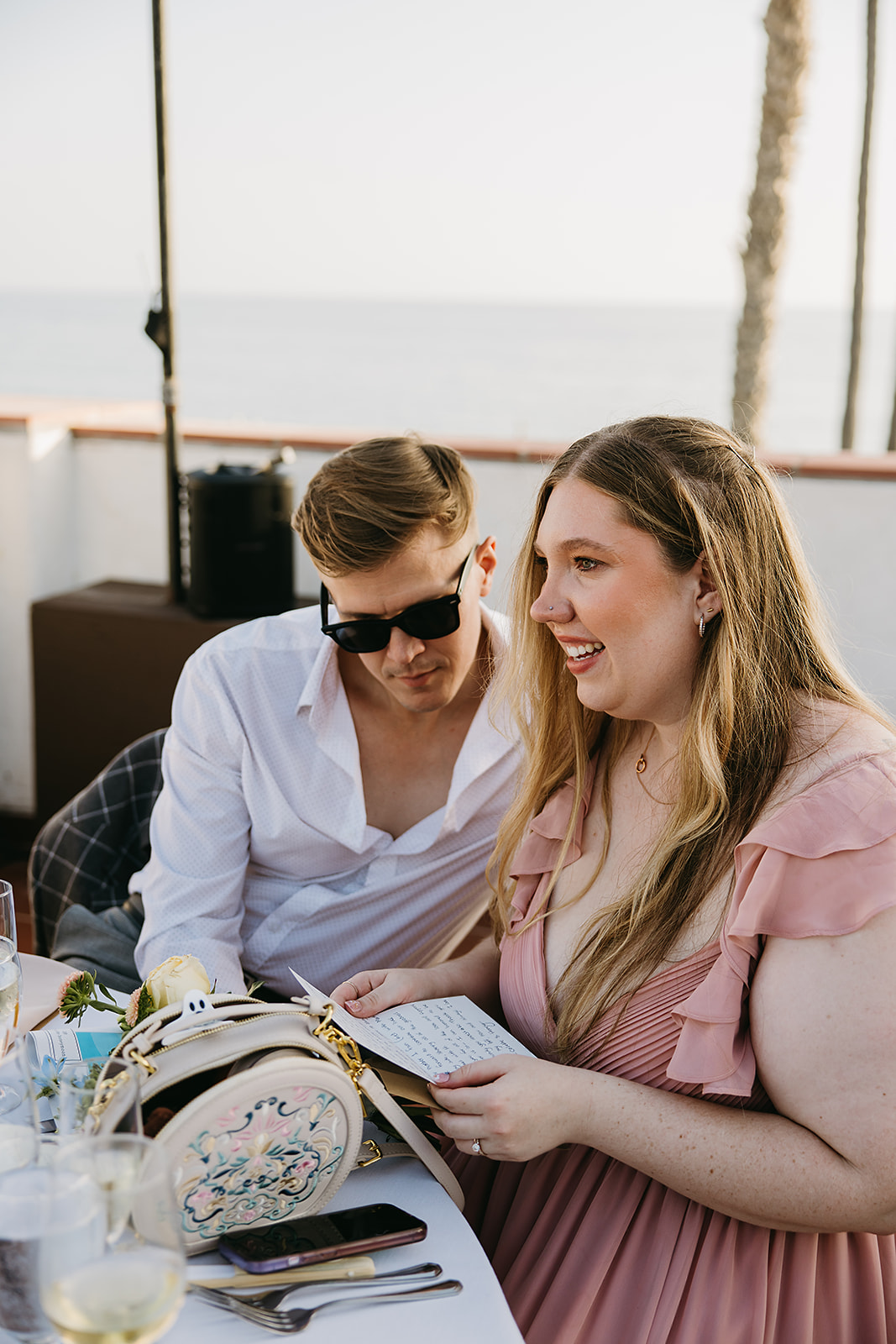 People reading hand written letters from the bride and groom at a wedding reception at Ole Hanson