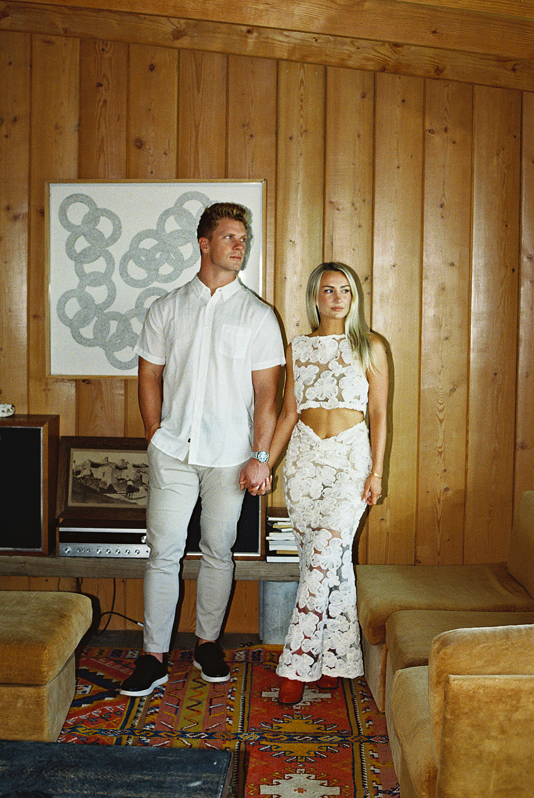 Couple indoors holding eachother takes joshua tree photos for their engagement session