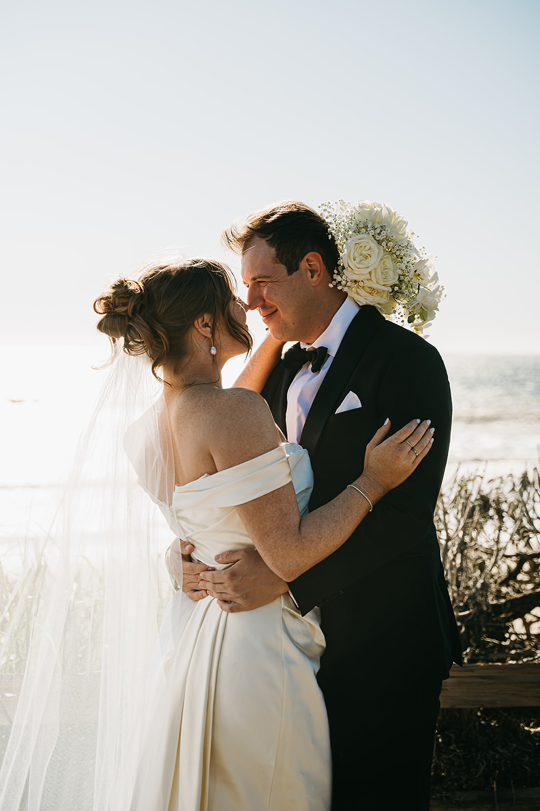 Bride and groom take wedding portraits outdoors at Ritz Carlton Bacara in Santa Barbara