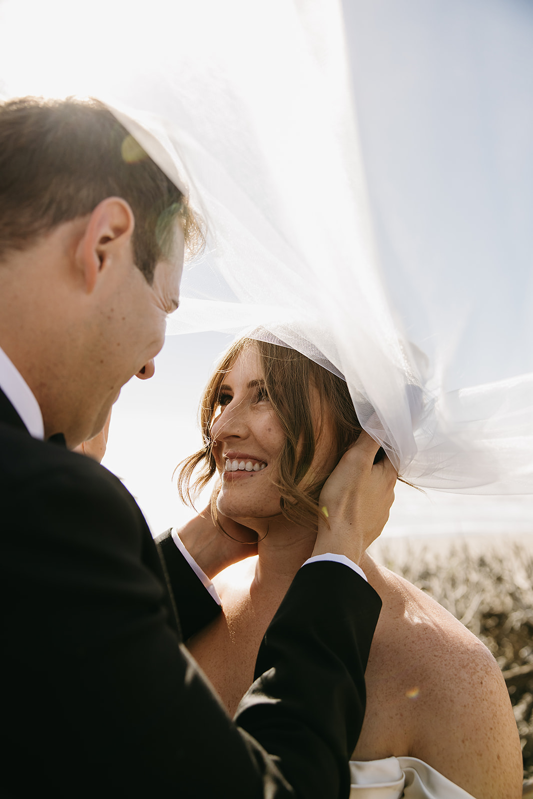 Bride and groom take wedding portraits outdoors at Ritz Carlton Bacara in Santa Barbara