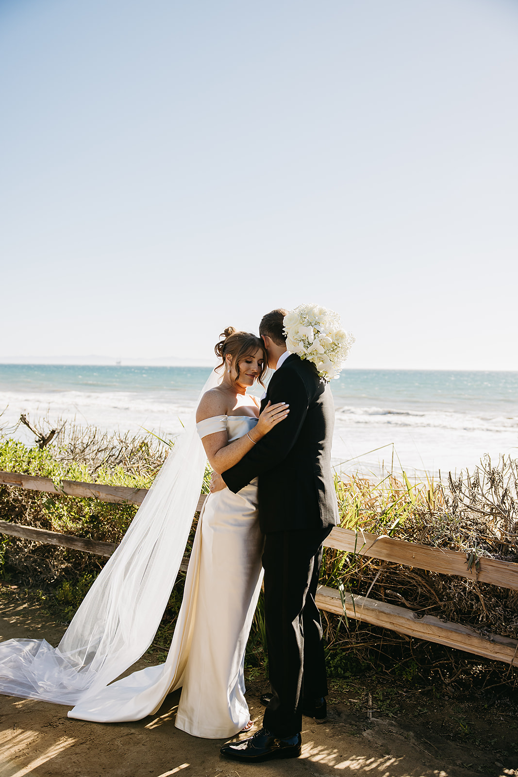 Bride and groom take wedding portraits outdoors at Ritz Carlton Bacara in Santa Barbara