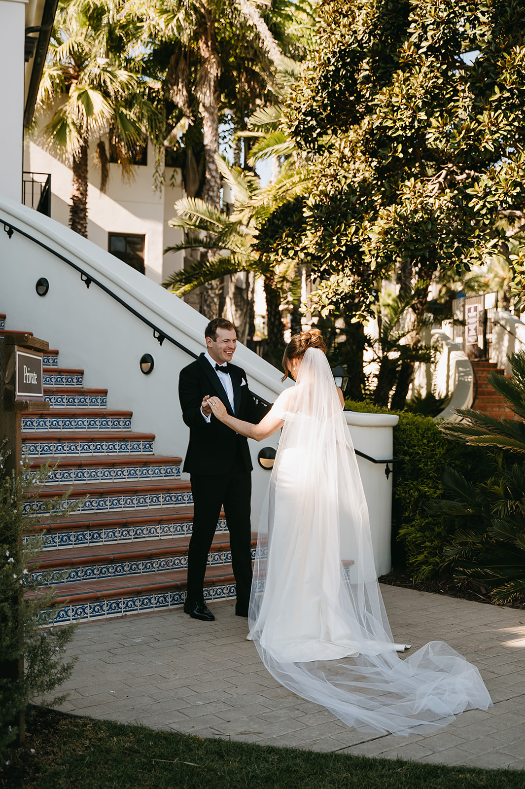 Bride and groom take wedding portraits outdoors at Ritz Carlton Bacara in Santa Barbara