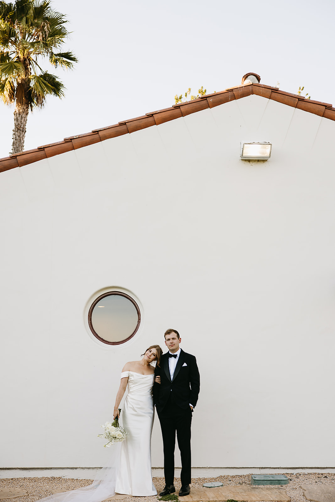 Bride and groom take wedding portraits outdoors at Ritz Carlton Bacara in Santa Barbara