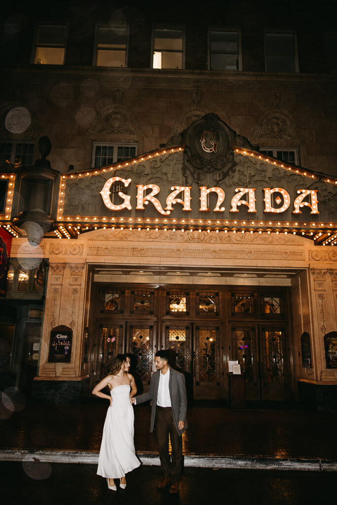 Bride and groom sit in a vintage convertible, the bride holding a bouquet. The lighting is dim, casting a warm glow inside the car for their santa barbara elopment