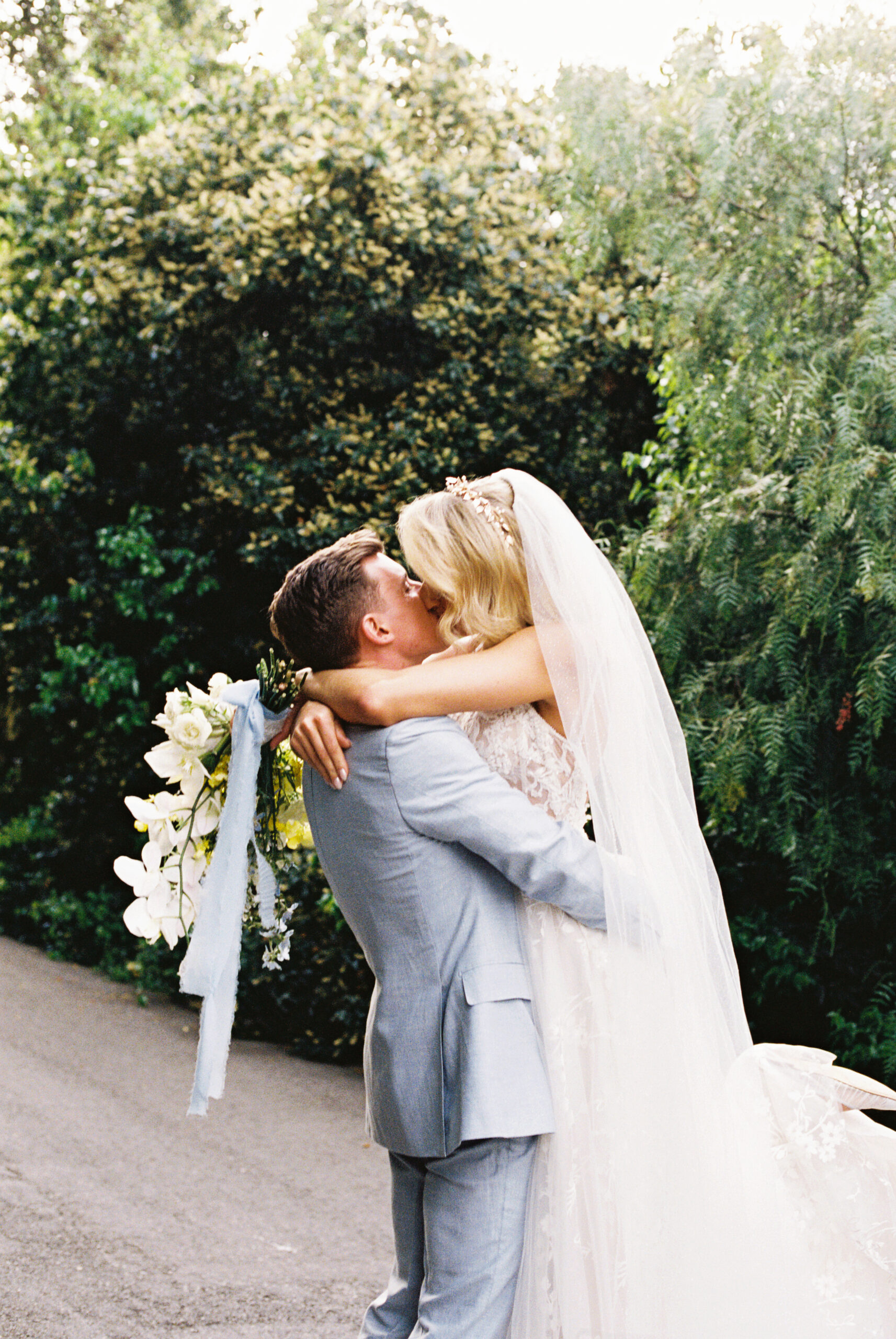 bride and groom taking portraits outdoors of their wedding venue the quail ranch in simi valley