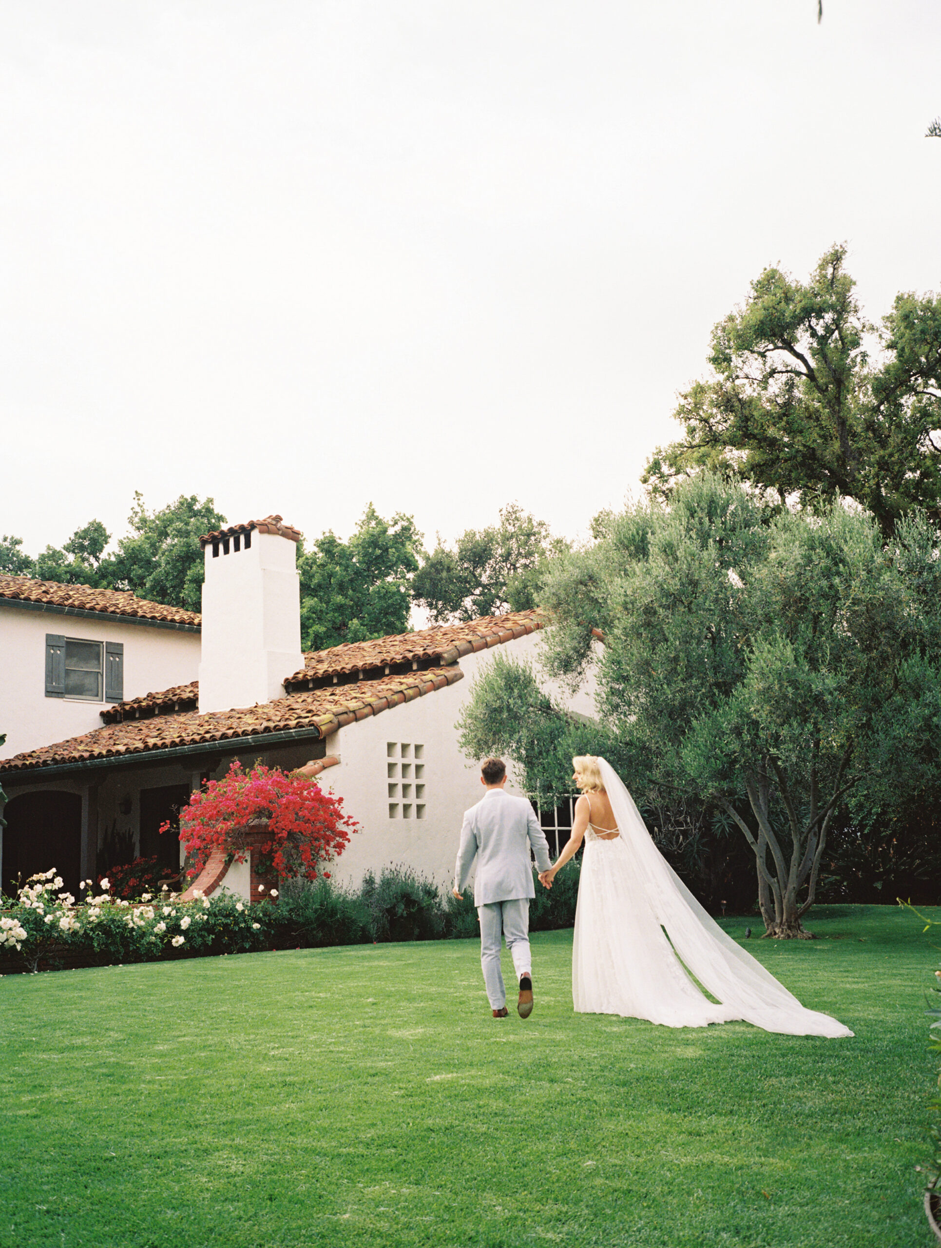 bride and groom taking portraits outdoors of their wedding venue the quail ranch in simi valley