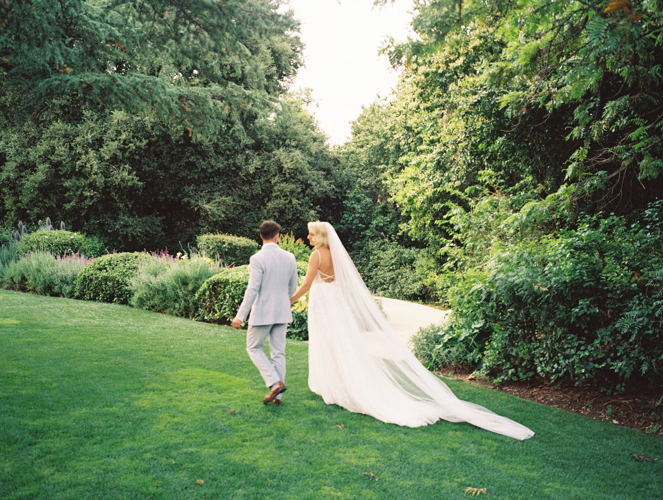 bride and groom taking portraits outdoors of their wedding venue the quail ranch in simi valley