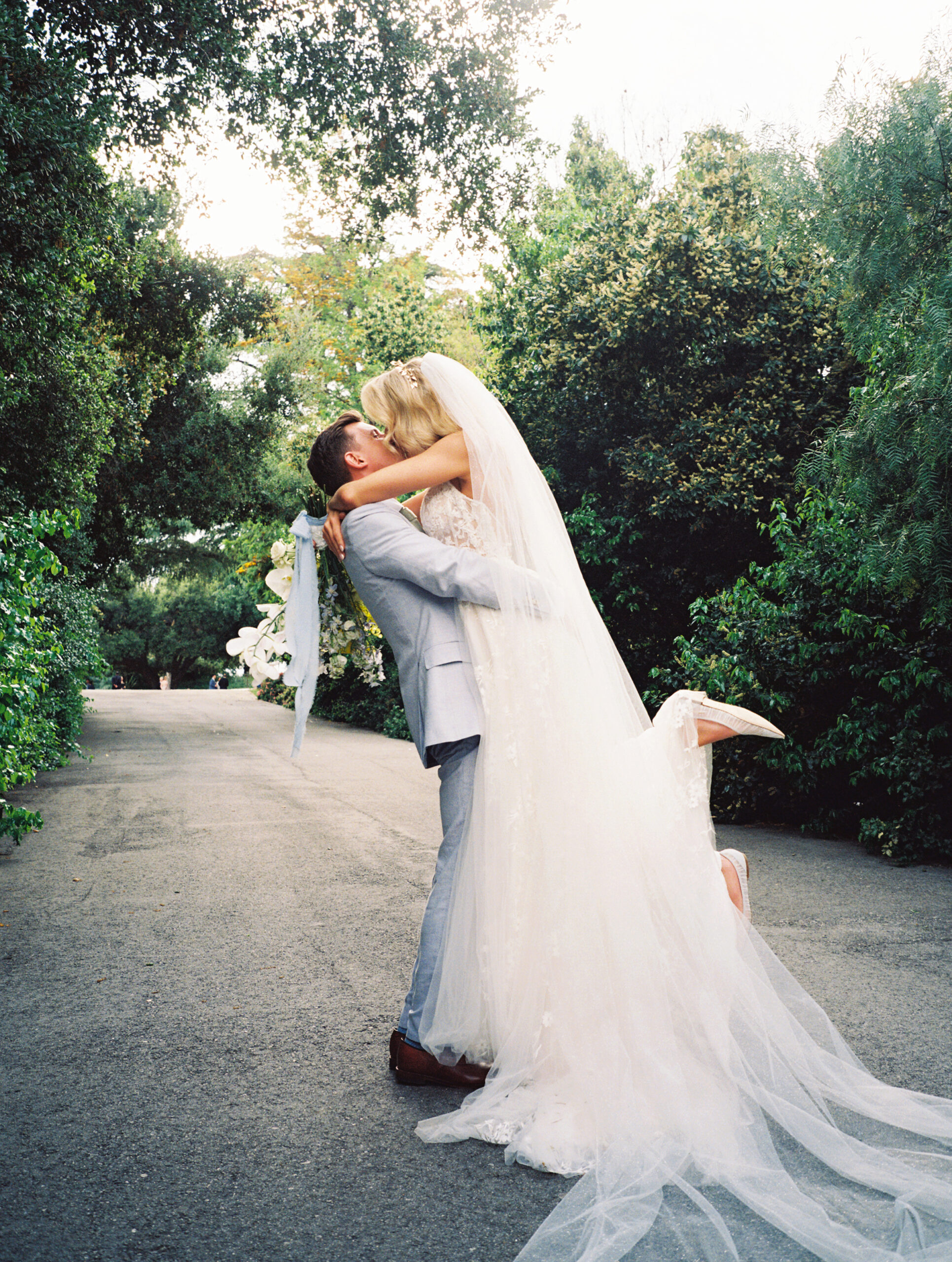 bride and groom taking portraits outdoors of their wedding venue the quail ranch in simi valley