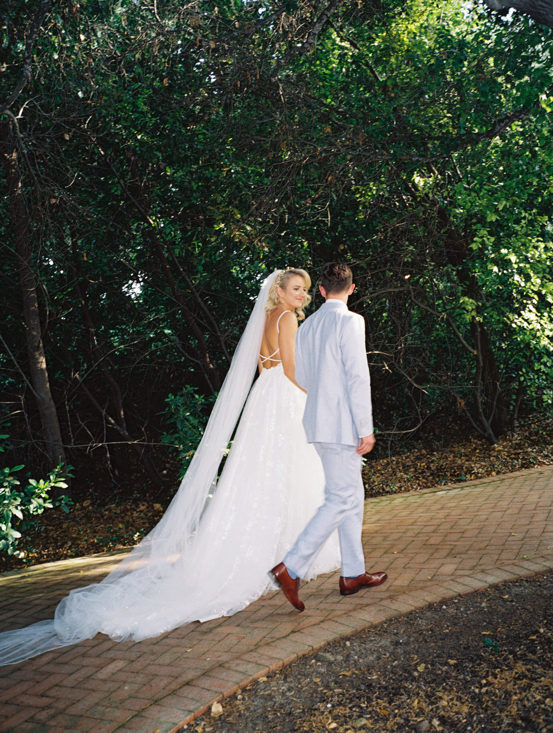 bride and groom taking portraits outdoors of their wedding venue the quail ranch in simi valley