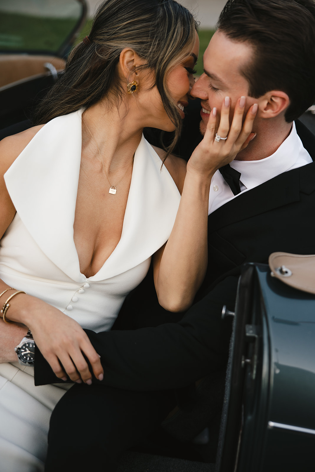 man and woman take engagement photos in LA outdoors by a vintage car