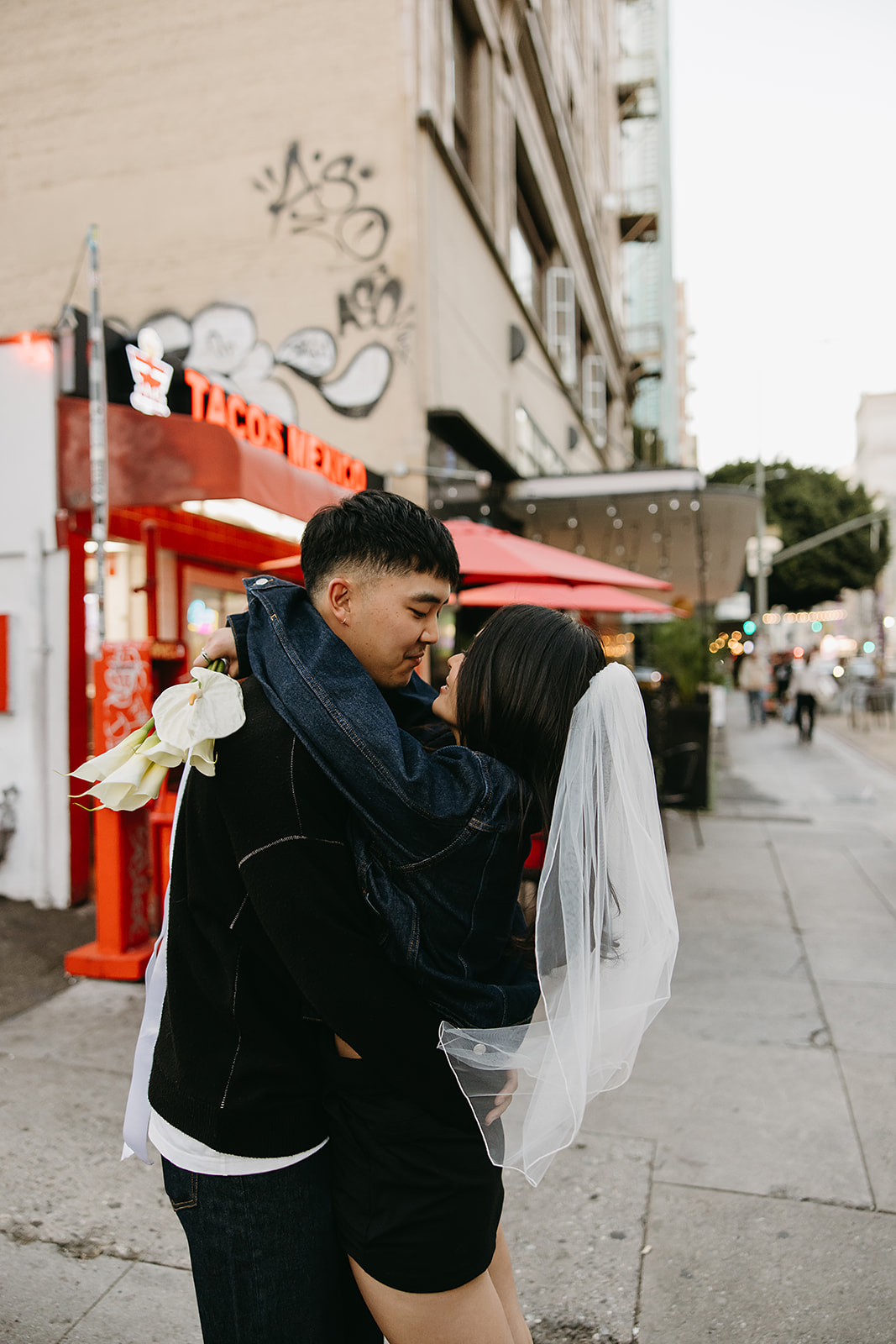 couple takes engagement photos on the street in downtown LA 