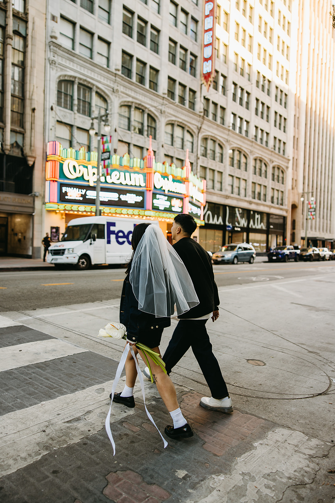 couple takes engagement photos on the street in downtown LA