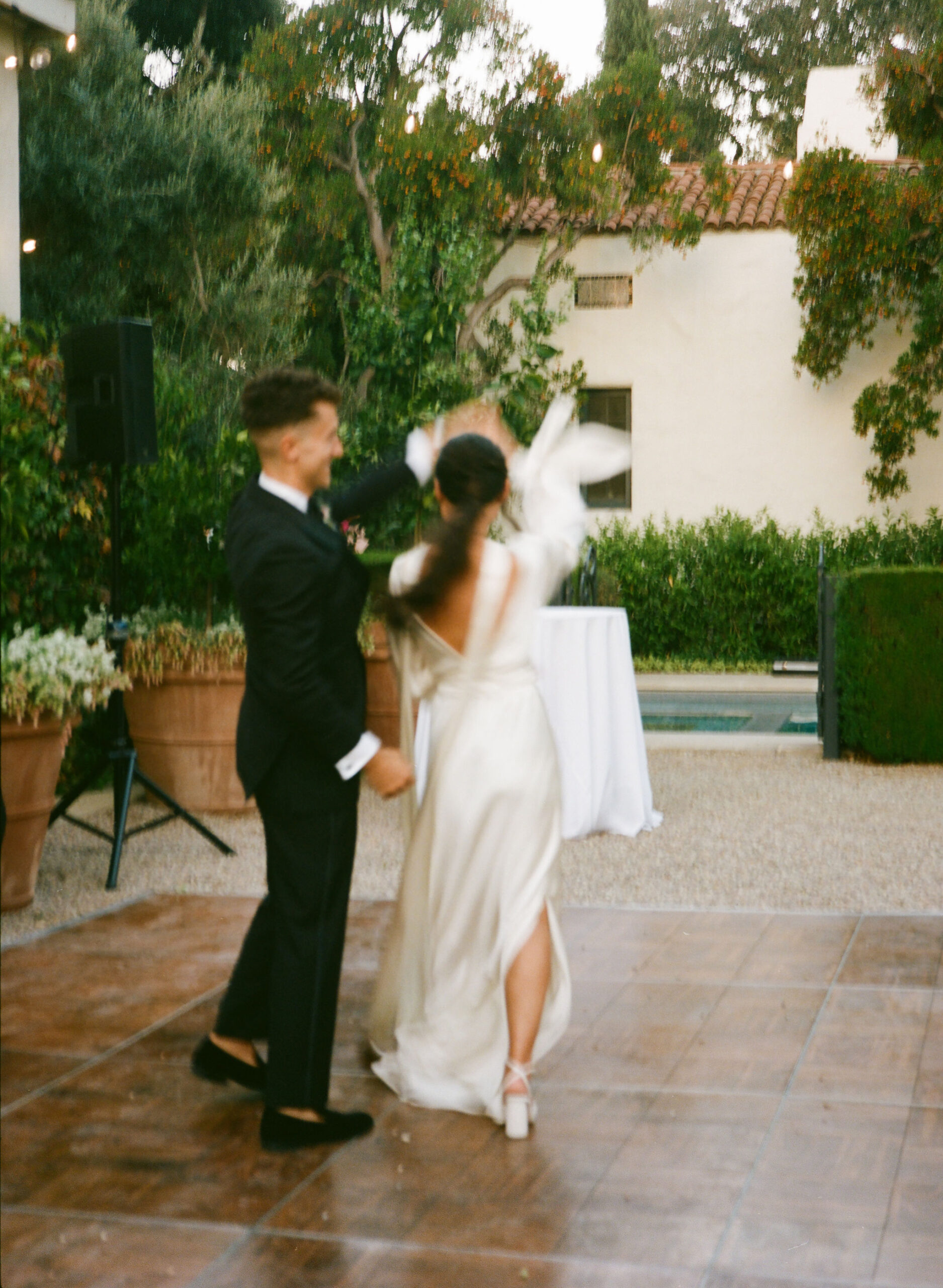 bride and groom dance and take their documentary style wedding photos outdoors