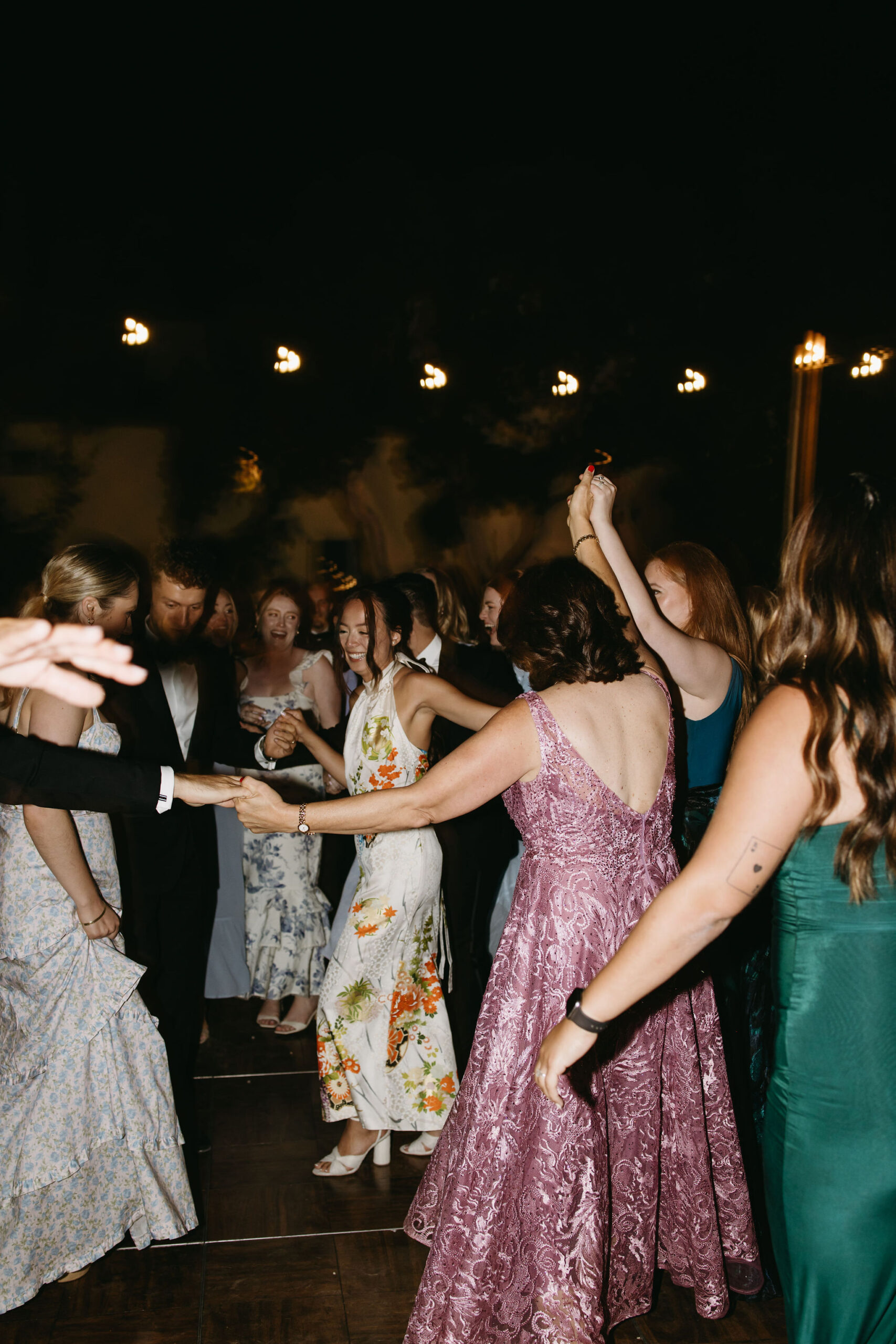 Guests enjoy dancing at a wedding reception at a private residence for a backyard wedding 