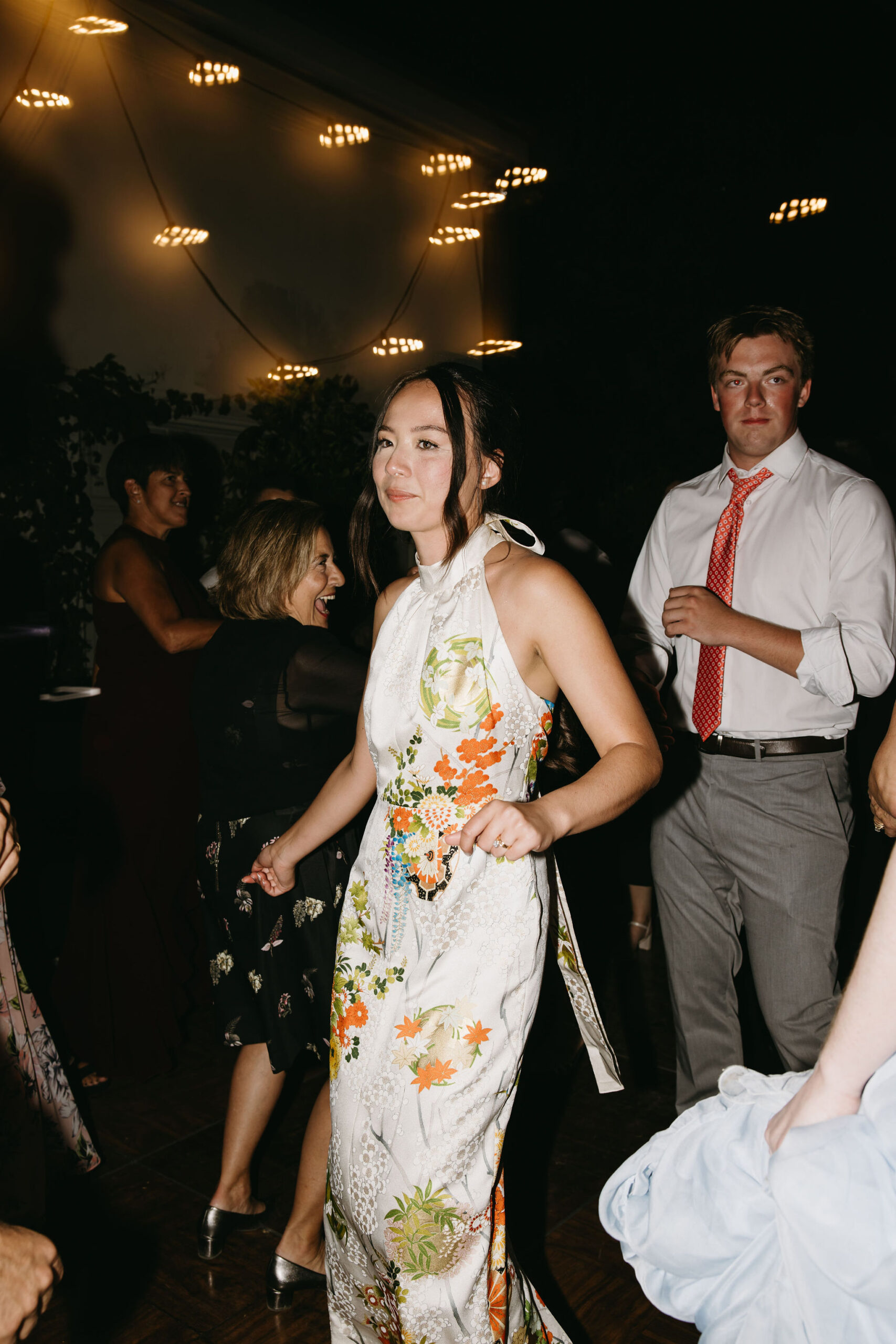 couple cuts cake at their wedding reception at a private residence for a backyard wedding 