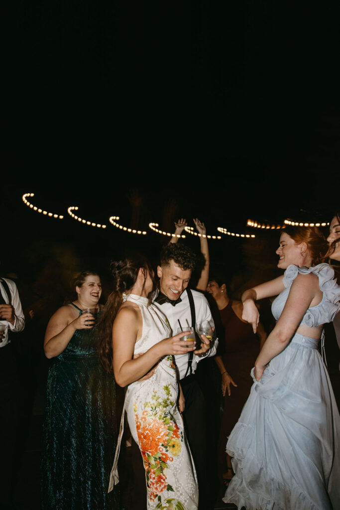 couple cuts cake at their wedding reception at a private residence for a backyard wedding