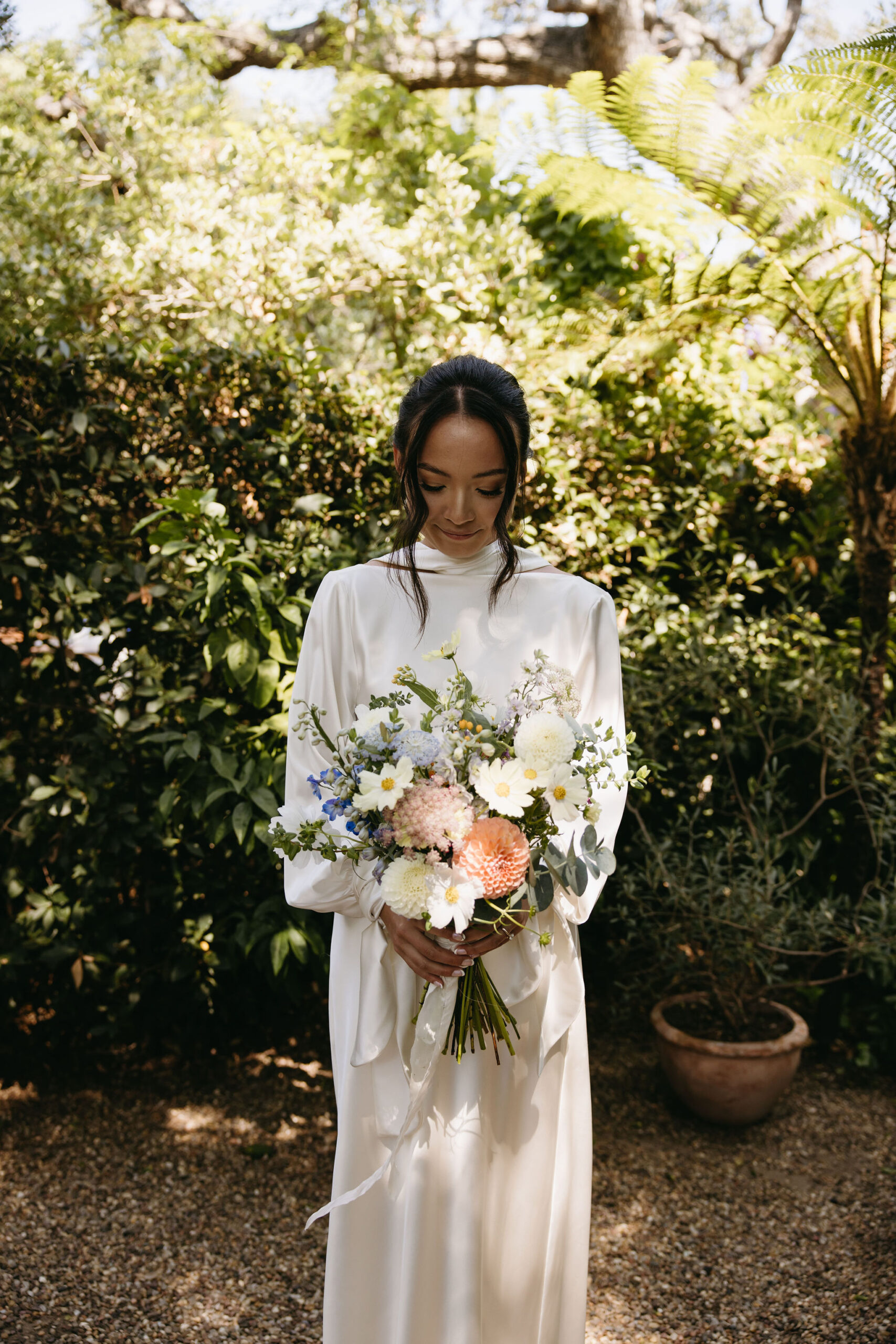 bride holding a colorful bouquet outdoors | documentary wedding photos 