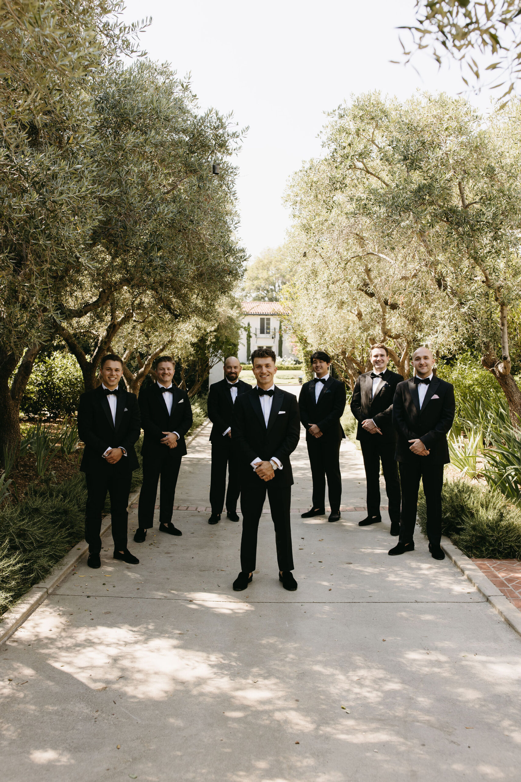 groom and groomsmen taking bridal party photos outdoors | documentary style wedding photos