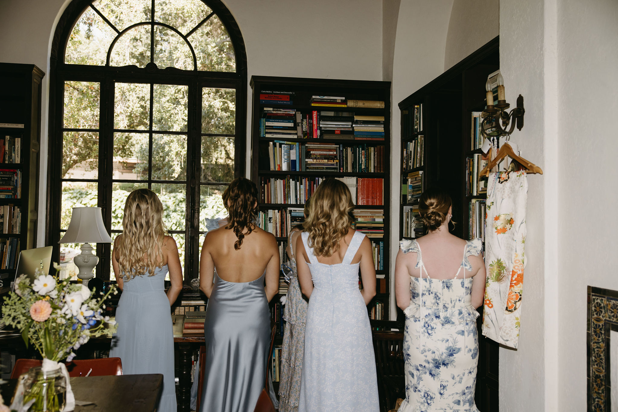 Bridesmaids turned around, waiting to have a first look with the bride